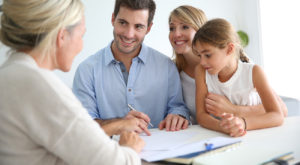 Young family signing bank documents