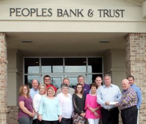 Peoples Bank & Trust presents a donation to Tornado Alley Turf Project