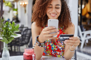 Woman entering her credit card information onto her mobile device