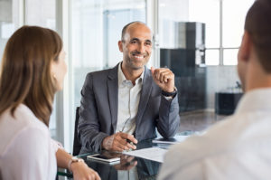 Bank employee meeting with young couple