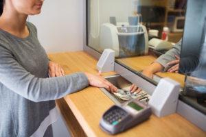 Woman withdrawing cash from her bank