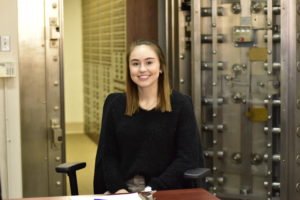 Peoples Bank & Trust Employee smiling while sitting at desk