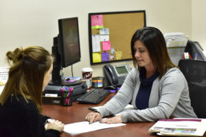 Peoples Bank & Trust Employee discussing document with customer