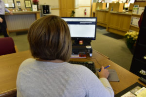 Peoples Bank & Trust Employee using computer