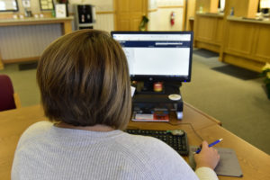 Peoples Bank & Trust Employee using computer