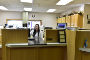 Peoples Bank & Trust Employee - Teller using computer