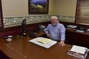 Peoples Bank & Trust Employee sitting at desk