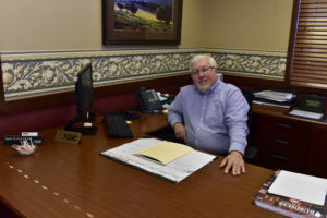 Peoples Bank & Trust Employee behind desk