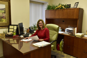 Peoples Bank & Trust Employee - consumer banker sitting at desk