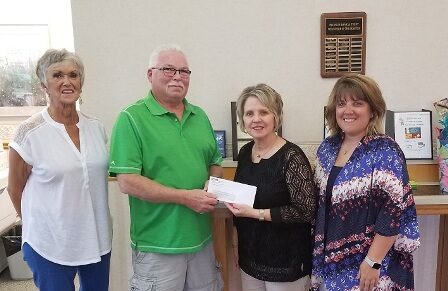 Peoples Bank & Trust presenting members of the Red, White, & Blue Days committee with a donation.